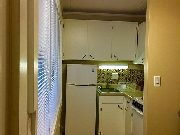 furnished kitchen including fridge, range/oven and some kitc