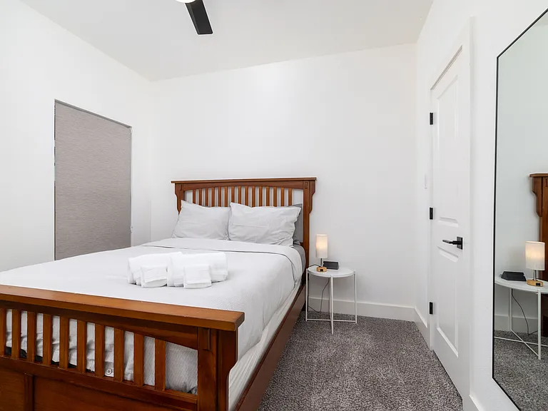 Second bedroom featuring queen bed and attached closet.