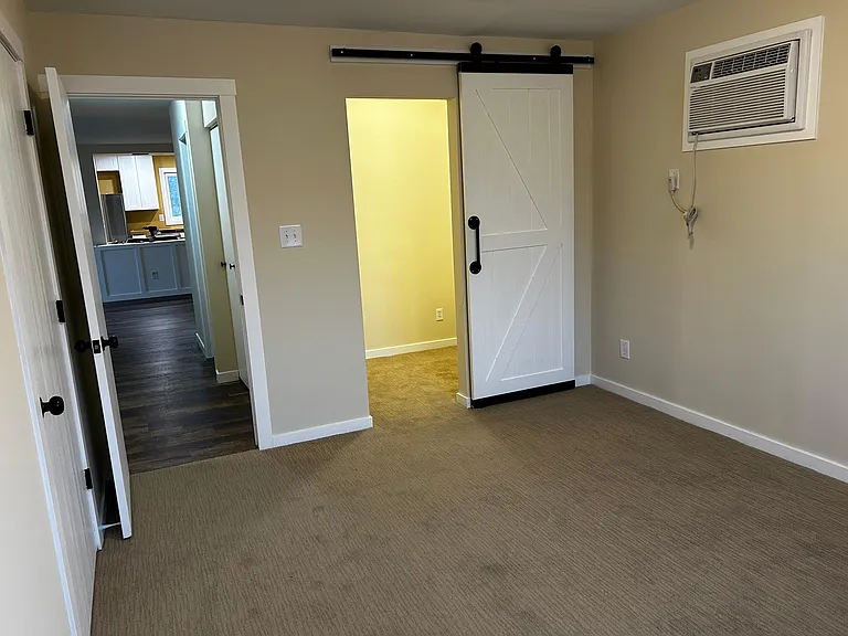 Master Bedroom Walk-In Closet with Farm Sliding door and Master bedroom AC.