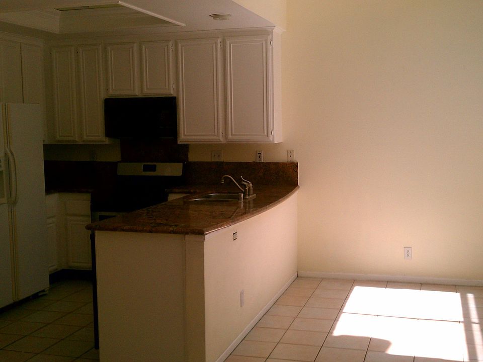 Bright kitchen with solid surface counter top, gas range/oven, pantry