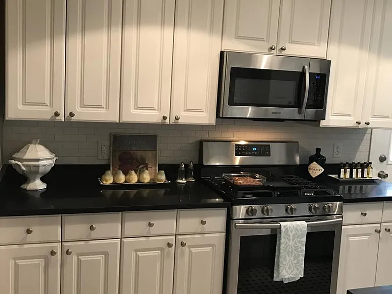 Recently renovated kitchen with new black quartz countertops and new stainless appliances. Lots of large cabinets!