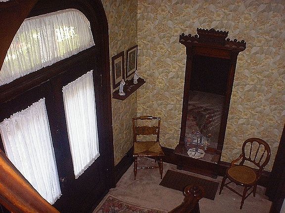 Entryway with curved walnut staircase.