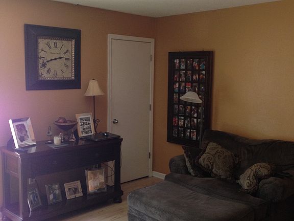 Living room with coat closet and sliding glass door to front