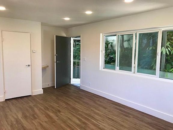 Entry to apartment off private patio with mature landscape