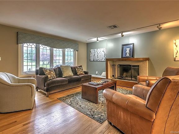 Large formal living room with pretty bay window and wood burning fireplace!