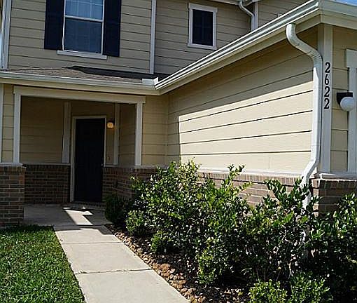 Pretty landscaping and cute front porch area invites you inside...