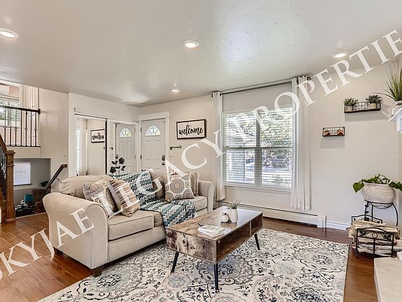 Living room and view of the staircase up to 2 bedrooms and bath and down to 1 bedroom and bath with extra living space that can be used as a family room or home office.