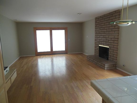 Familyroom with fireplace and hardwood floors, sliding Pella
