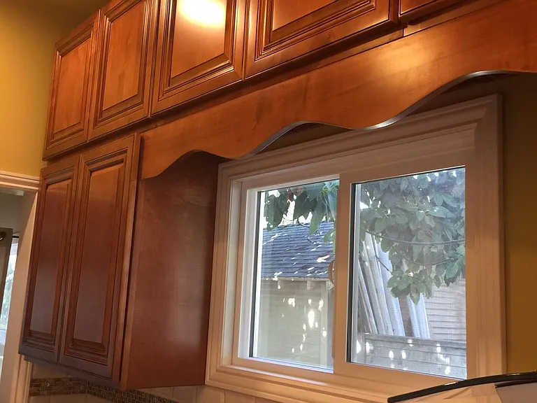 more detail of countertop/backsplash just inside entry on right side and cabinetry and windows for good daylight