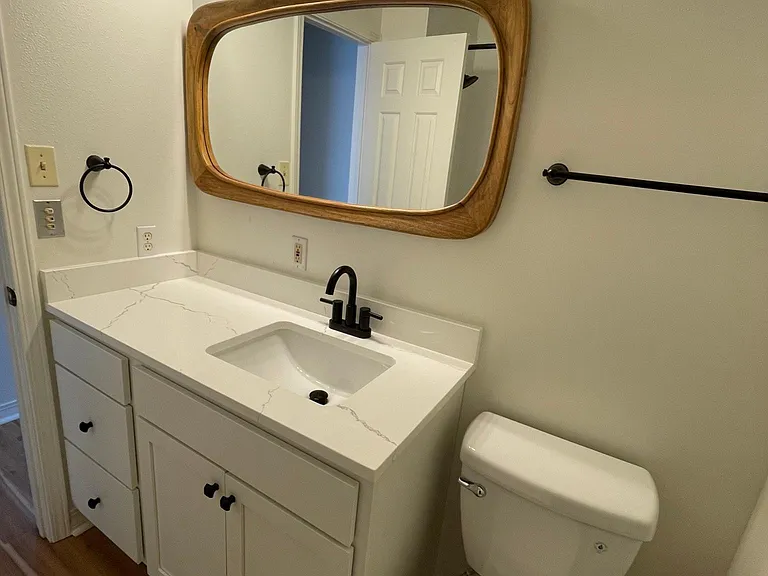 Primary bath with hand picked finishes, quartz countertop, new toilet, new cabinets! All new flooring throughout townhome!