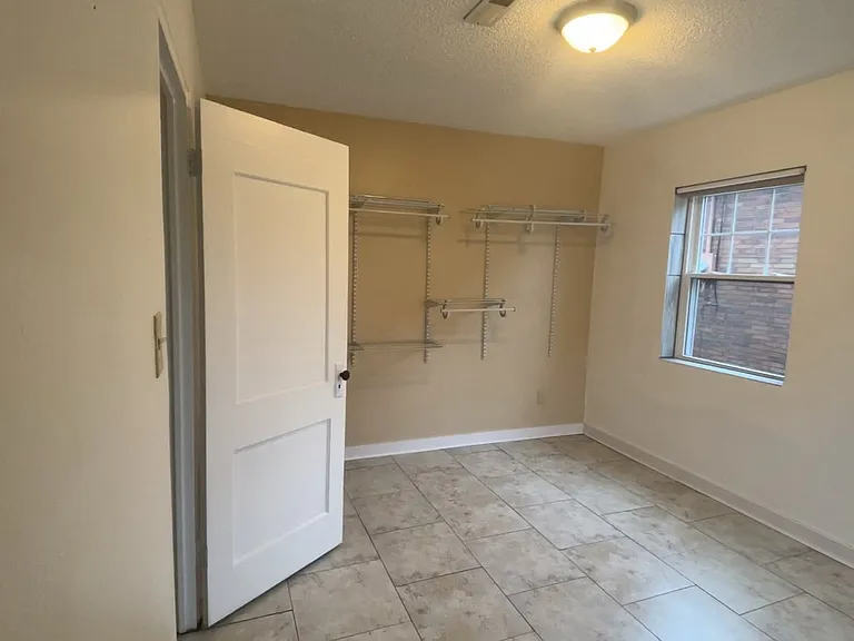 (1) of (2) Bedrooms fitted with:
Large walk-in closet clothing organization rack system and (1) additional built-in closet.
Warm tone "rustic adobe" wall paint as accent.
Large windows with plenty of light.