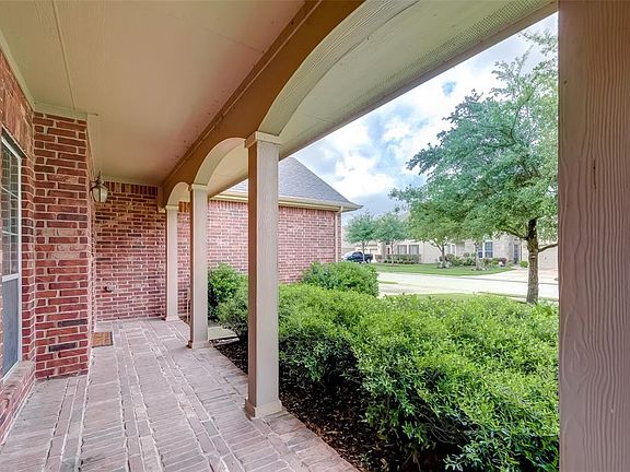 Covered front porch, perfect for cool night enjoyment in this quiet neighborhood.