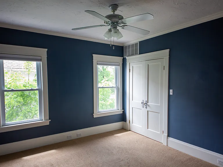 Beautiful bedroom accented with rich designer paint tones, oversized trim, and great natural light.
