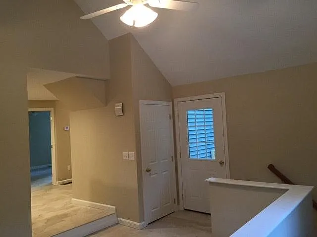 Entryway, small coat closet, door to back deck, staircase to finished basement