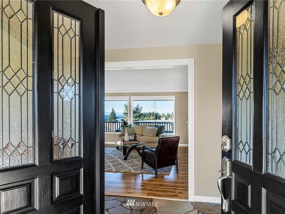 Doouble-Door entry to home opens up to a view through the Living Room Windows.