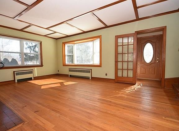Step inside to the bright & spacious living room with original woodwork and a wood burning fireplace.