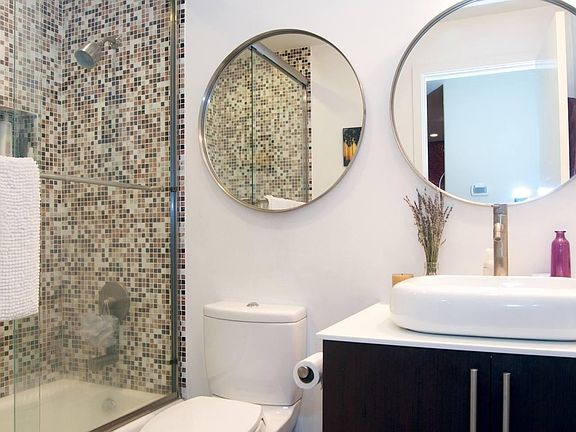Renovated bathroom with custom tile, bathtub/shower combo