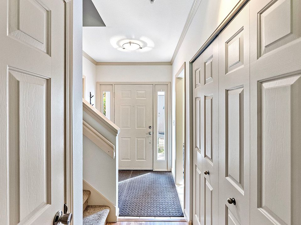 Entry hall with view back to front door. Large hall closet and water-heater/broom closet under stairs.