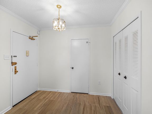 Entry foyer with brand new luxury vinyl plank flooring, one walk-in closet and a coat closet