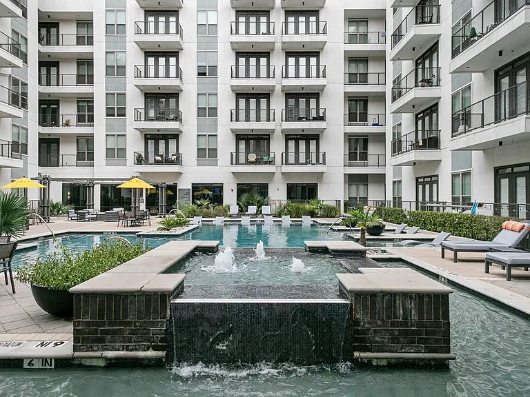 Fountain at pool and pool facing apartments
