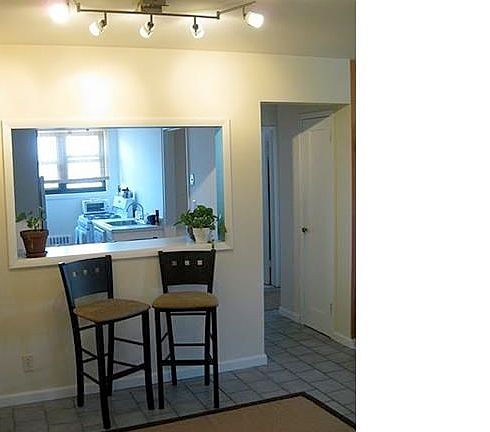 Entrance Foyer with Tile Floors in Foyer and Bedroom/Kitchen/Bathroom Hallway - Offers Space for Dining Area/Coffee Bar/Breakfast Bar; Charming Open Window to Eat-In Kitchen, Track Lighting.