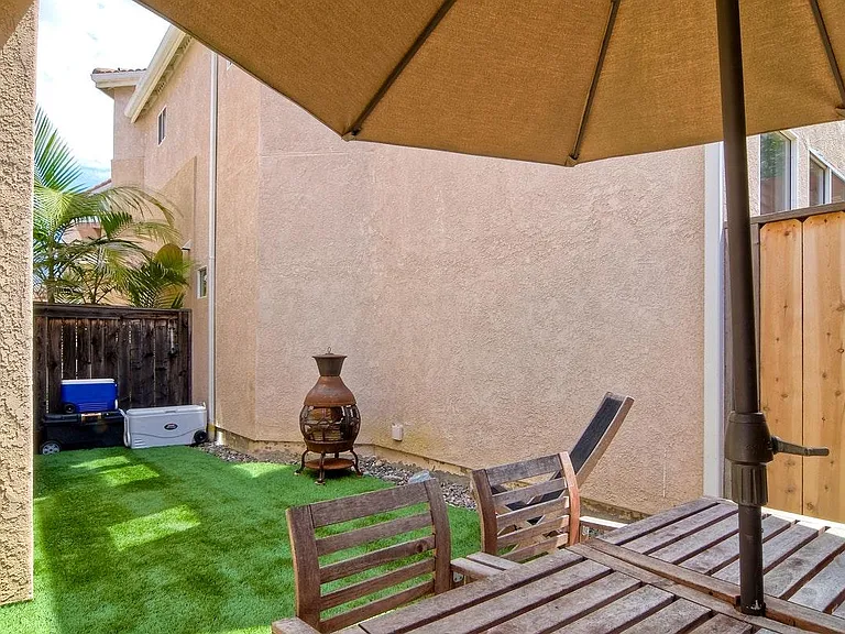 Enclosed backyard with turf