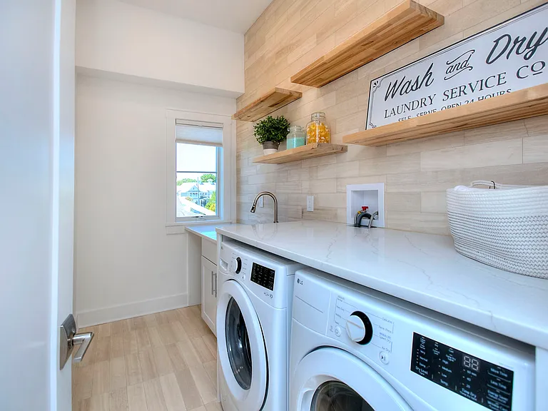 Laundry room with large finished storage closet.