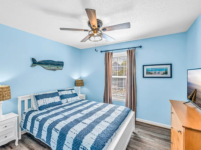 Queen bed in second guest bedroom.