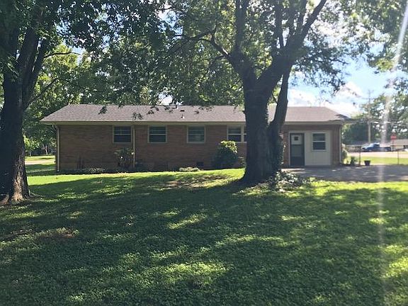 Large shady fenced backyard with gorgeous trees.