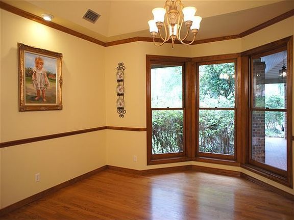 The formal dining room is huge with large bay windows