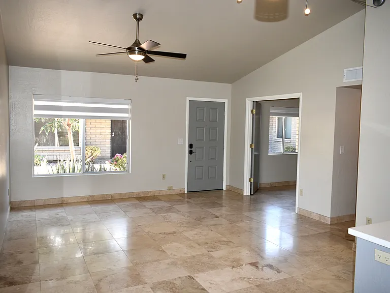 View of Living Room from the Dining Area. Living Room window looks out to shared courtyard.