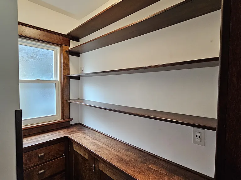 Unit includes a large, off-kitchen, pantry and storage area. Pantry window equipped with privacy glass.