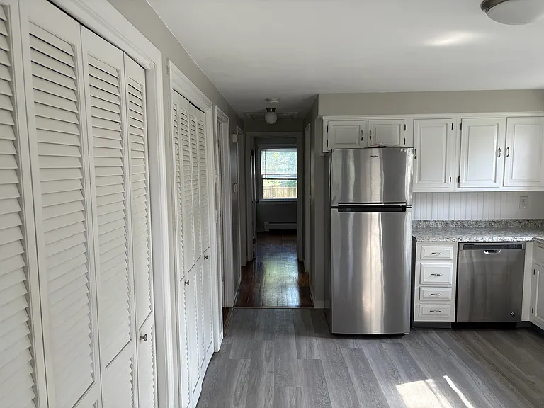 hallway to bedrooms and bathroom, much storage along the wall