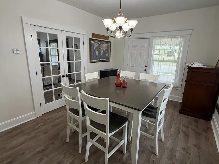 Dining room featuring a door leading to the front porch & French doors opening into the living room.