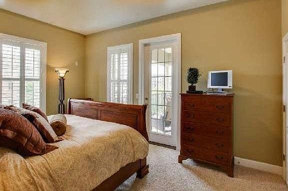 Master Bedroom, walk in closet and exit to gated patio. Has new hardwood floors.