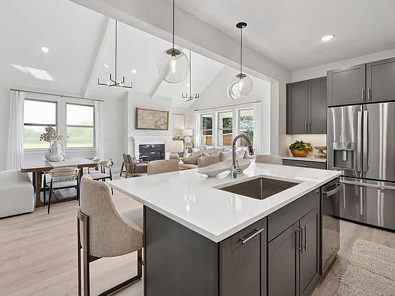 Kitchen overlooking open concept living spaces