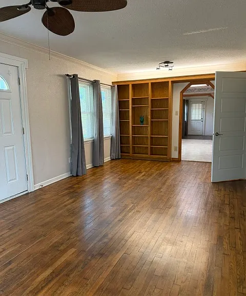 living /dining room features wall of built in shelving