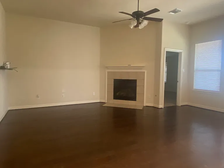 Open living room with a cozy gas fireplace _ perfect for hosting or relaxing on a quiet night in.