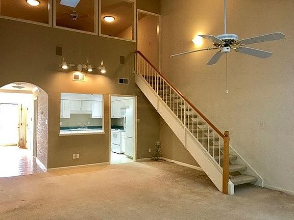 Living room with stairs to loft and extra bedroom