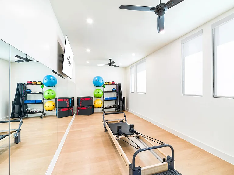 Stay active with Modera Trailhead's fitness studio, featuring a variety of equipment including a Pilates reformer for balanced workouts.