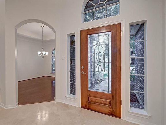 A handsome leaded glass door graces the entry to the home.