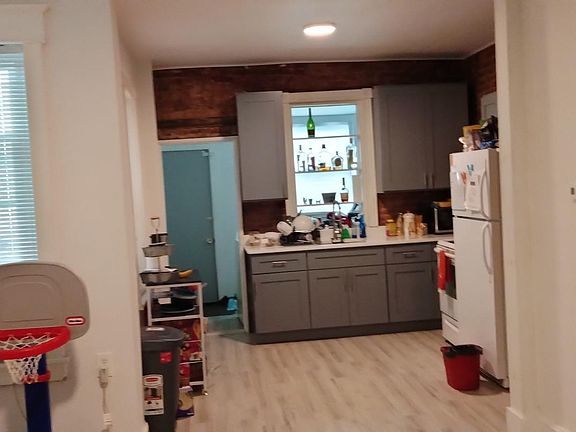 Kitchen with laundry area behind it