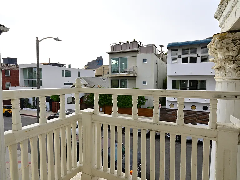 private balcony with ocean views overlooking multi-million dollars homes