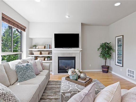 White vinyl windows, freshly refinished hardwood floors and gas fireplace all await you here in the living room! Notice the built-in storage shelves in the alcove next to the fireplace and all the recessed lighting!