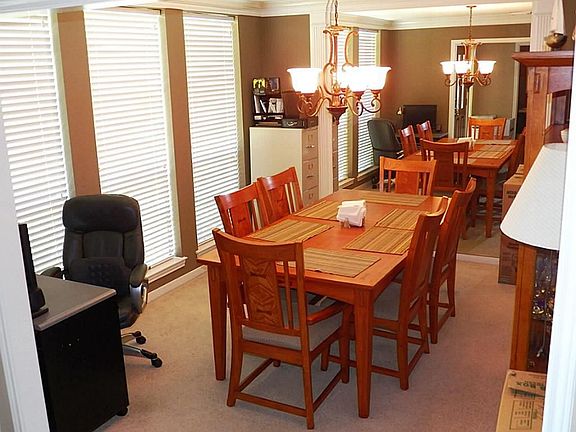 Formal Dining room with crown moulding and accent mirror.  Direct access to the Kitchen makes entertaining easy.
