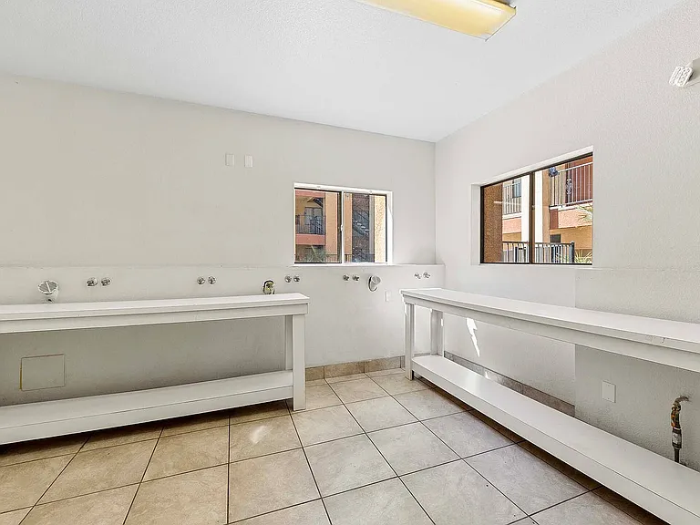 Experience convenience in this airy laundry room with ample workspace.