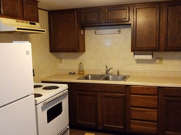Opposite of kitchen, with plenty of cabinet space and clean appliances, as shown