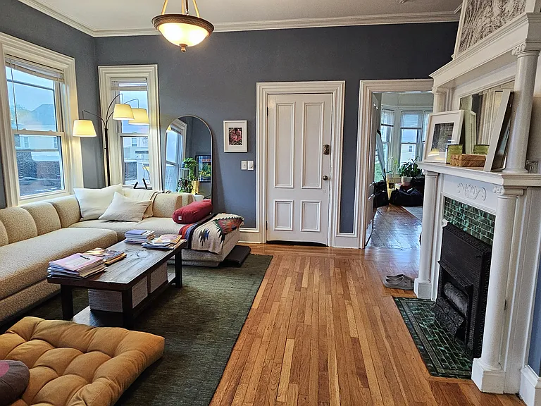 Large, sunny, living room area, with view into master bedroom suite