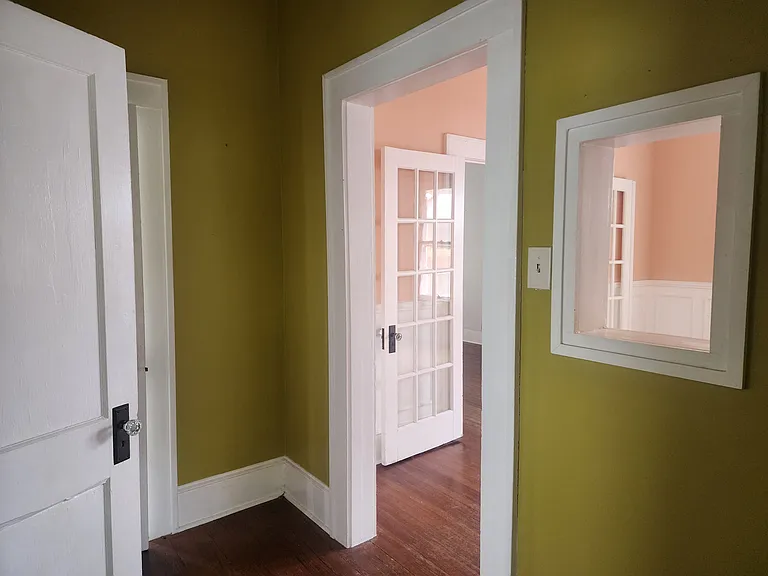 Hall between bedrooms, bathroom, and dining room