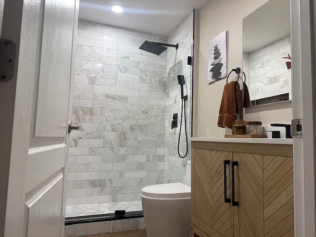 Fully upgraded bathroom with modern design, walk-in shower, and elegant finishes.